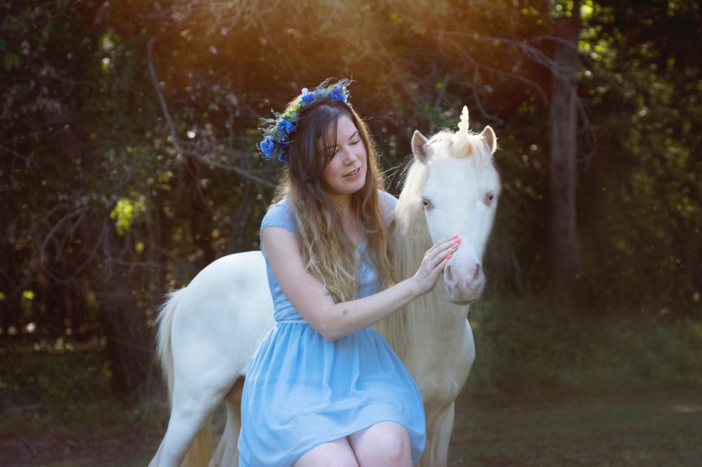 brittany with a unicorn in the meadow magical photography