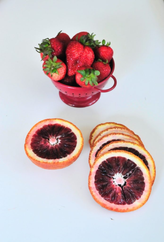 slice the blood oranges and strawberries to make white sangria
