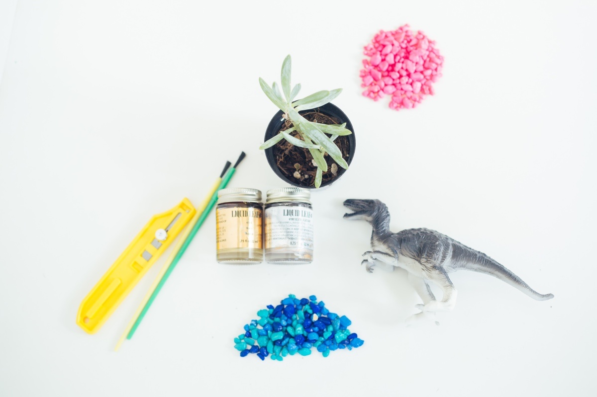 supplies to make a succulent planter with a dinosaur toy