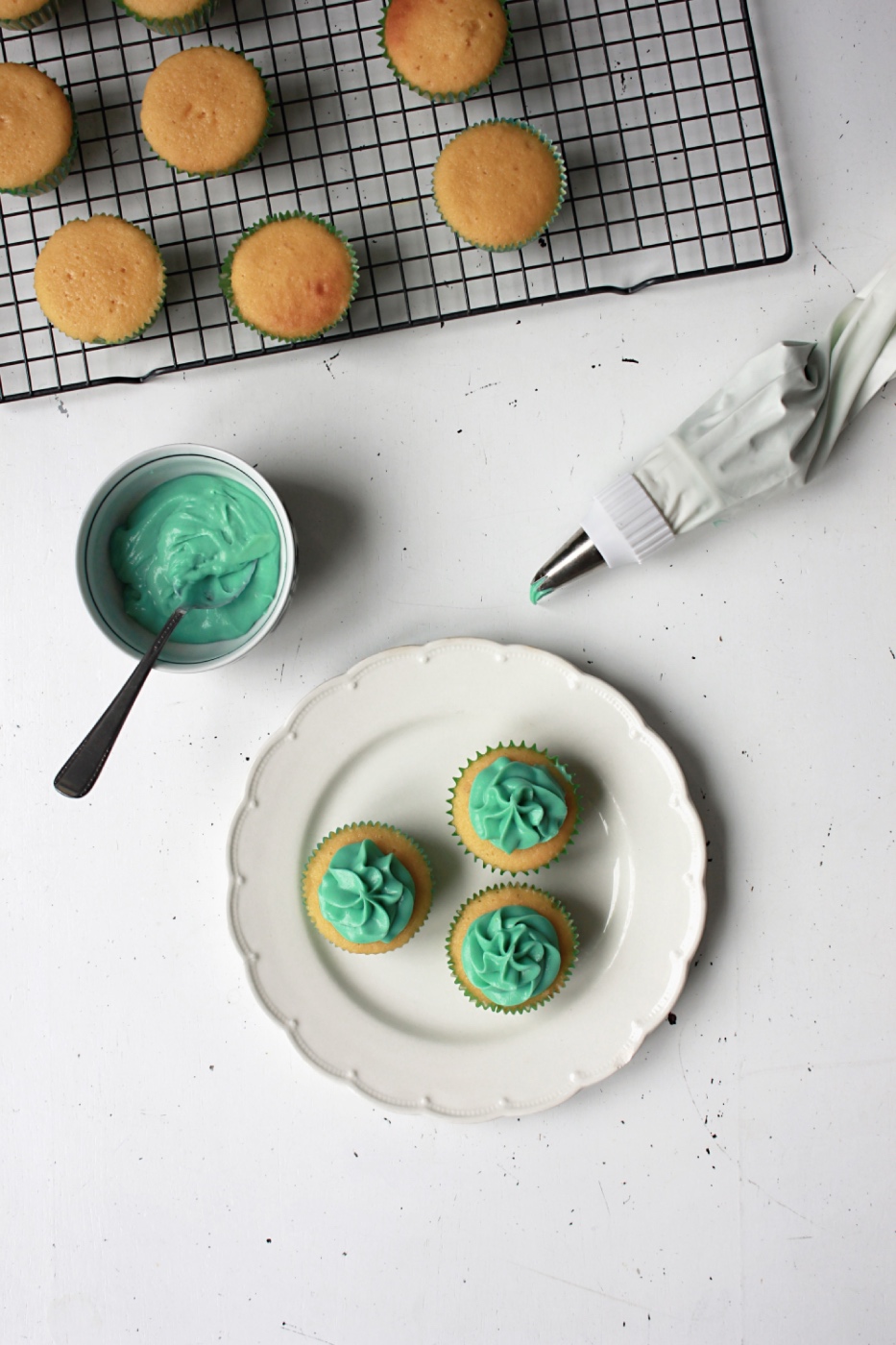 adding green frosting to the buttermilk cupcakes pop shop america
