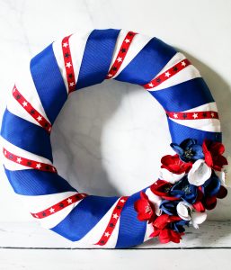 adding flowers to diy patriotic wreath