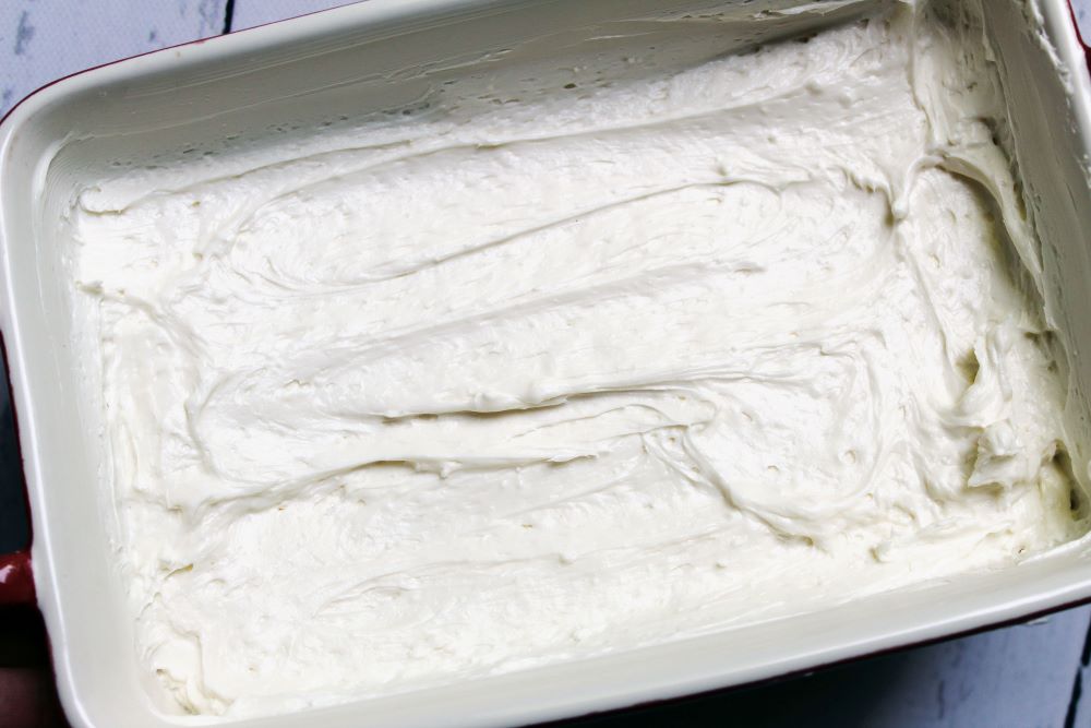 goat cheese spread in the baking pan