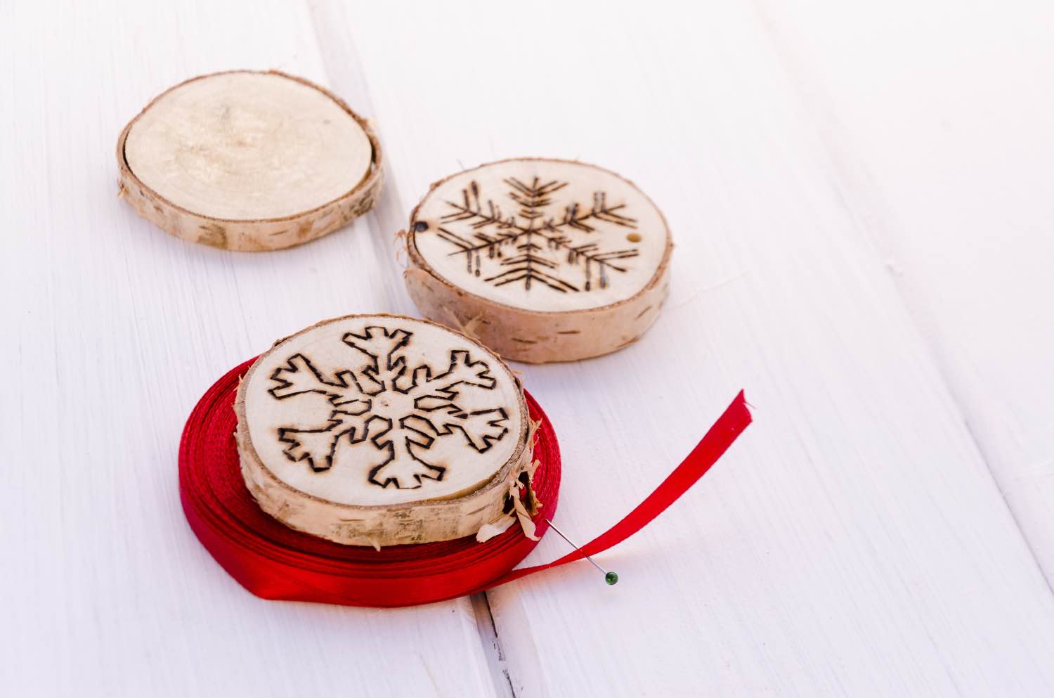 string wood burned ornaments with holiday ribbon pop shop america