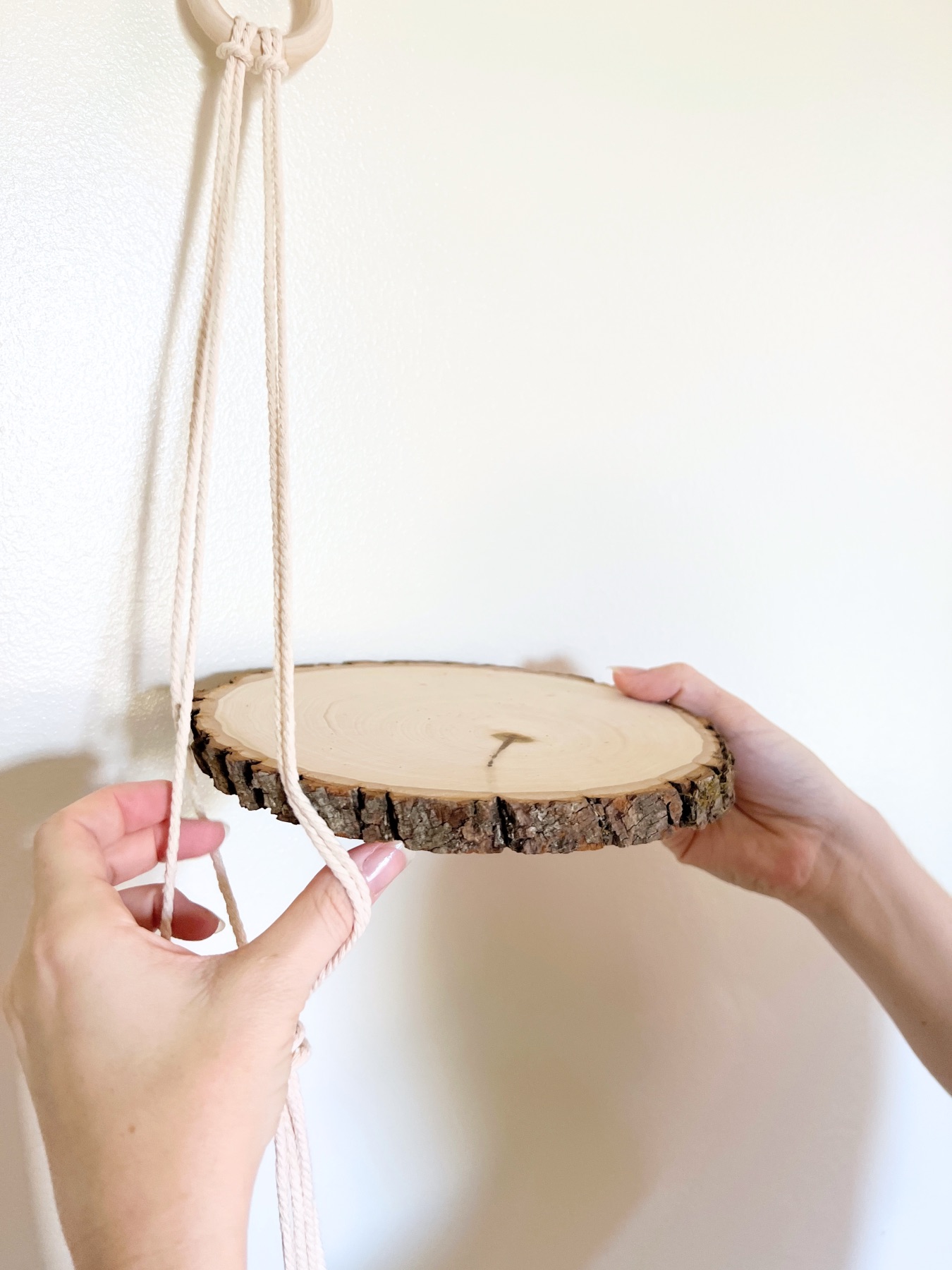 place the wood inside the macrame cords