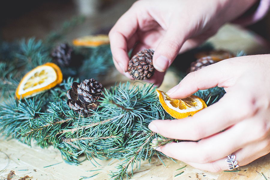 Attach pine cones to DIY natural Christmas wreath how-to