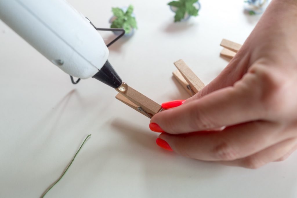 use a drop of hot glue to make diy flower clothespins