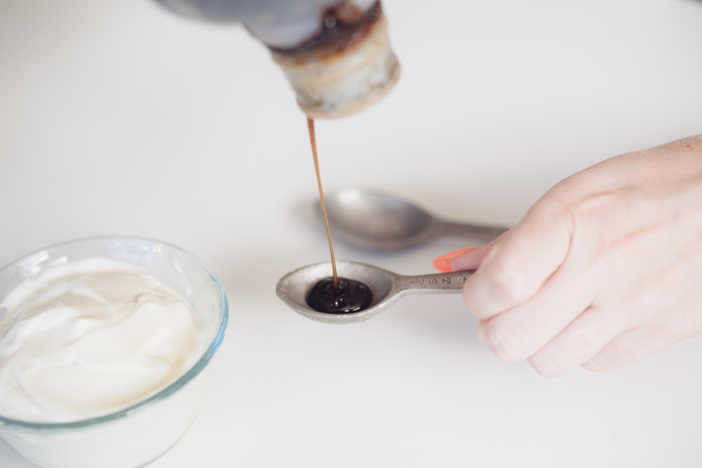 adding the vanilla bean paste to make homemade vanilla frozen yogurt