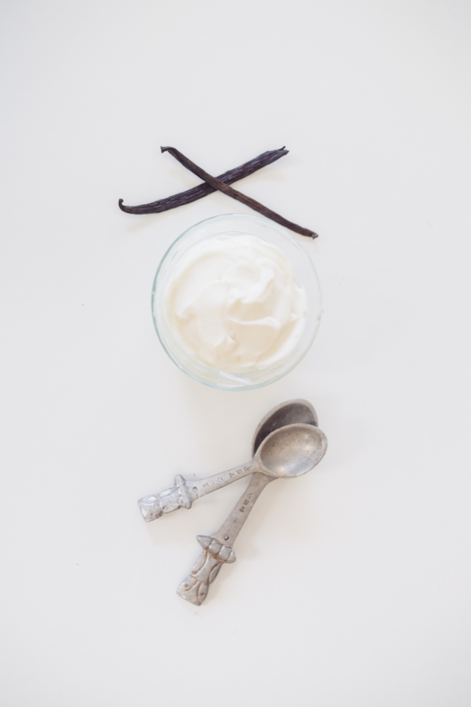 vanilla beans yogurt and spoons supplies to make triple vanilla bean frozen yogurt