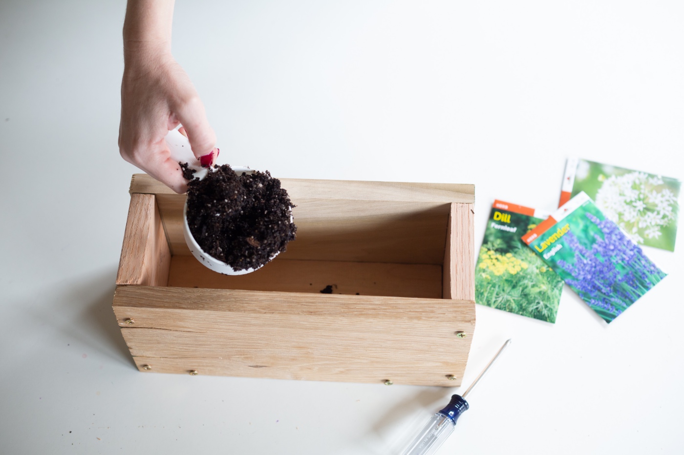 add soil to the diy wood planter box - gardening diy tutorial