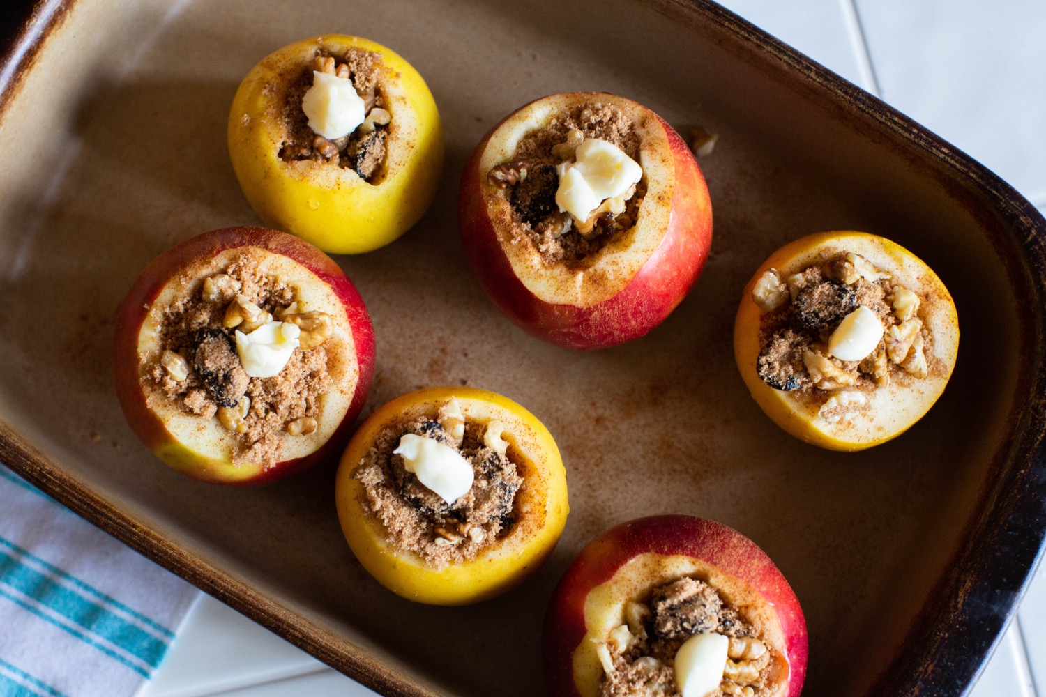 baked apples with cinnamon cherries and walnuts ready to bake