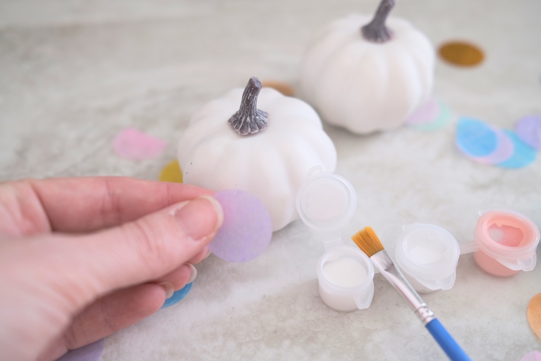 add paper confetti to the faux pumpkins with mod podge