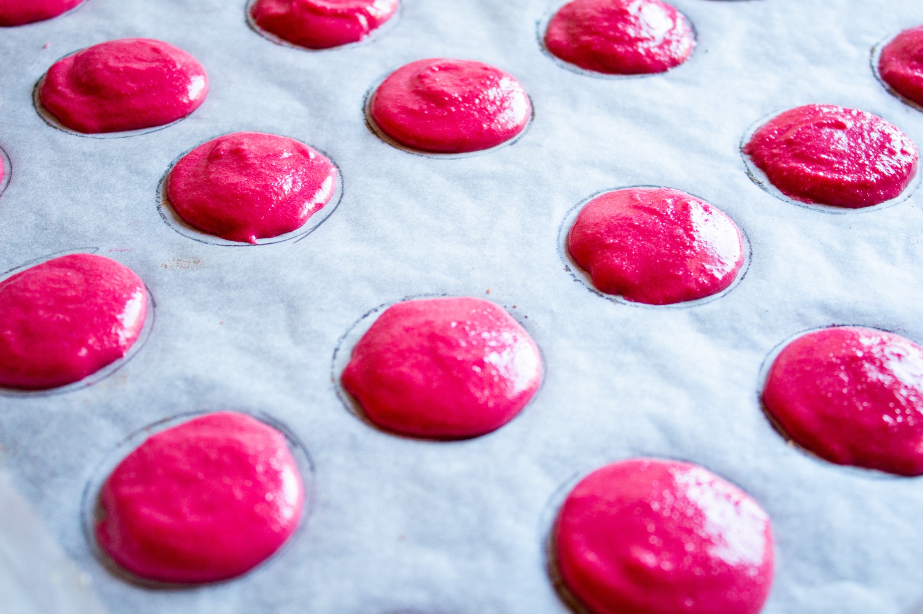 close up of macaron cookies on a cookie sheet
