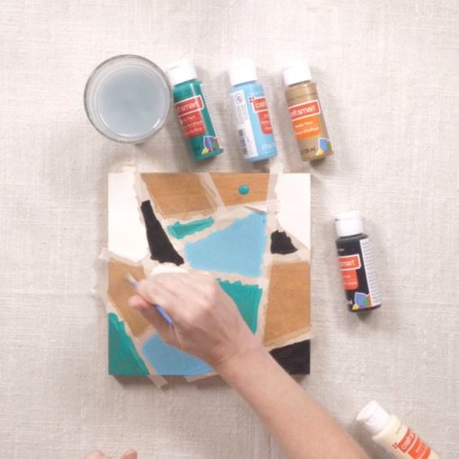 painting inside the painters tape to make a chevron square