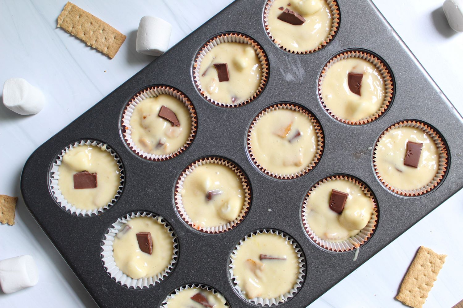 s'mores cupcake batter in muffin tin