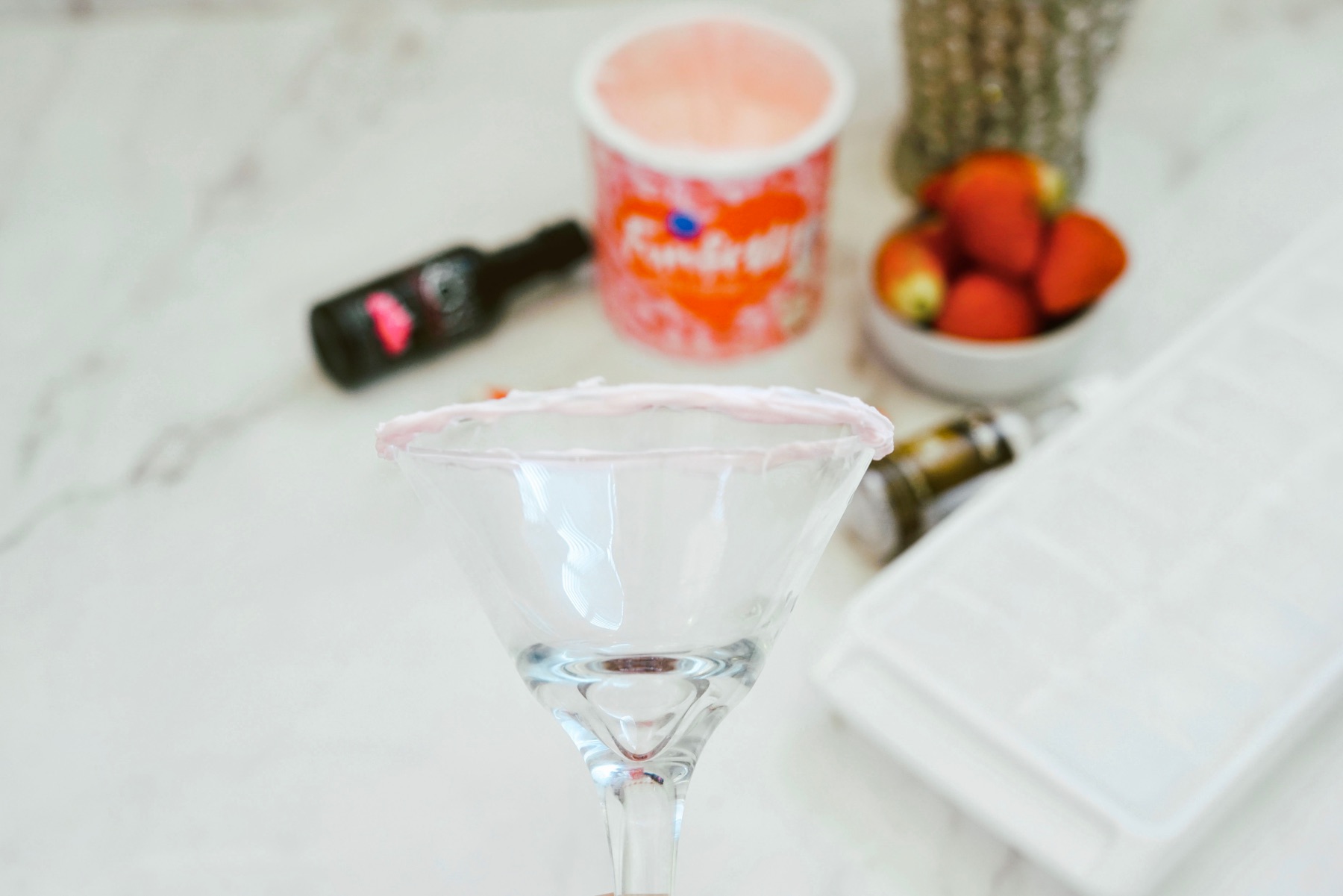 paint the glass rim with strawberry frosting
